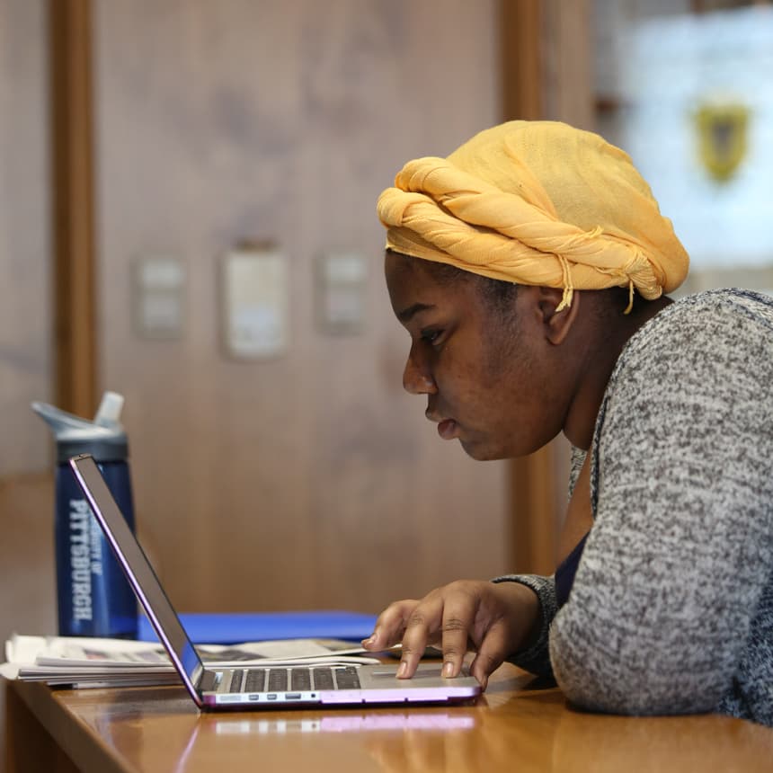 Pitt student studying in the library